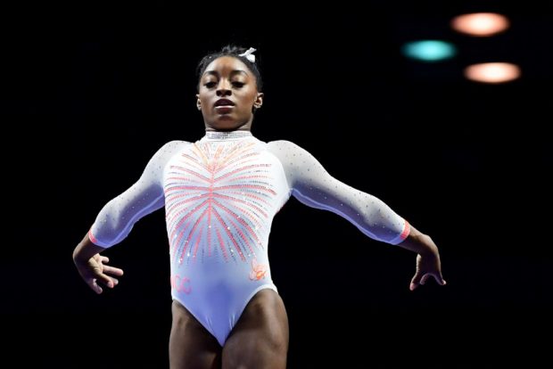 Biles makes history with Yurchenko double pike, wins title ...