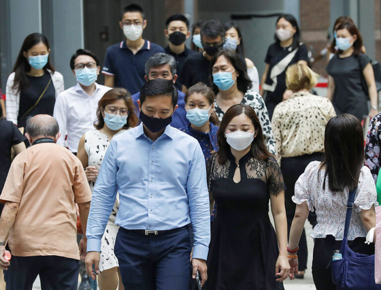 Singapore shifts virus focus to hospitalizations as cases surge